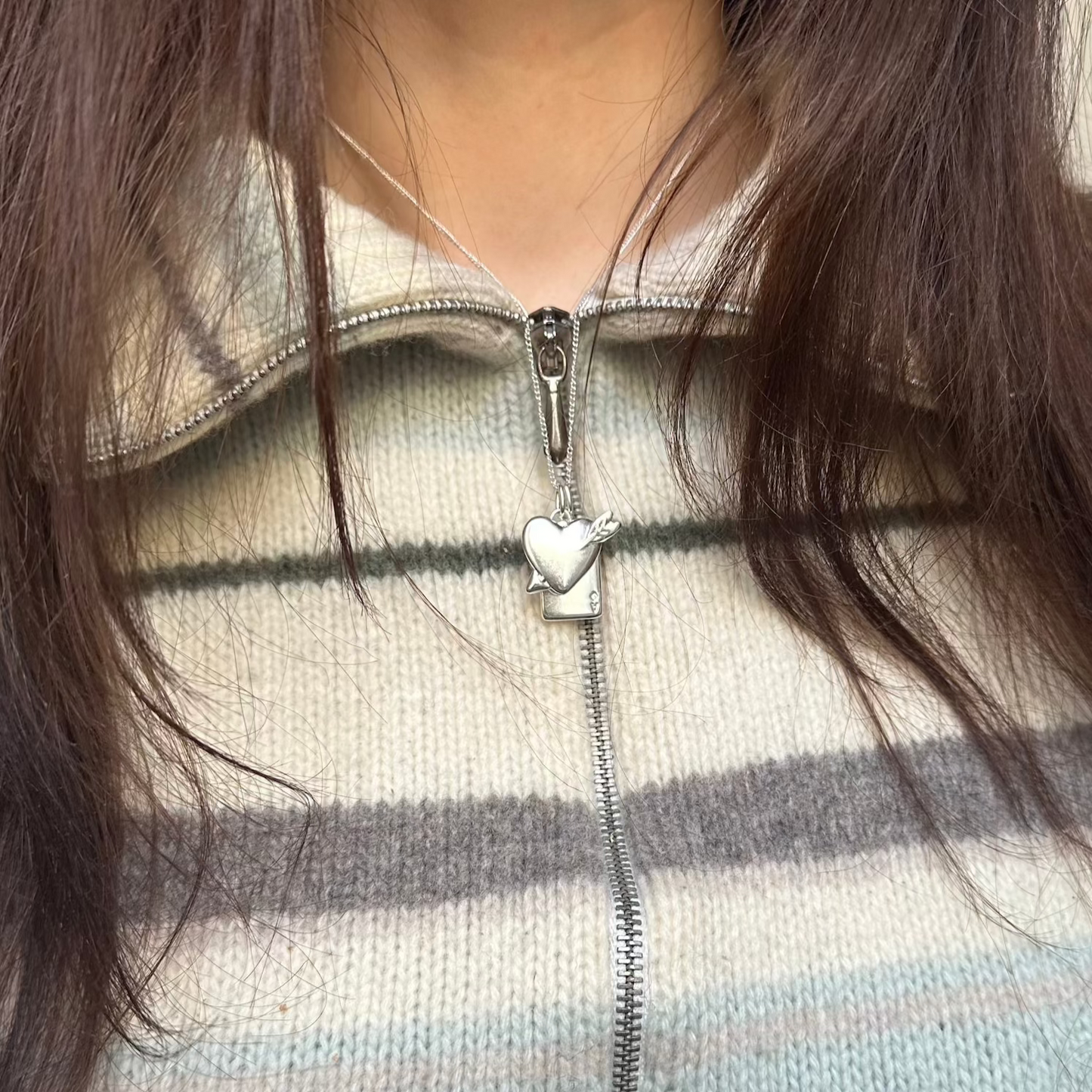 into you necklace worn on woman close up
