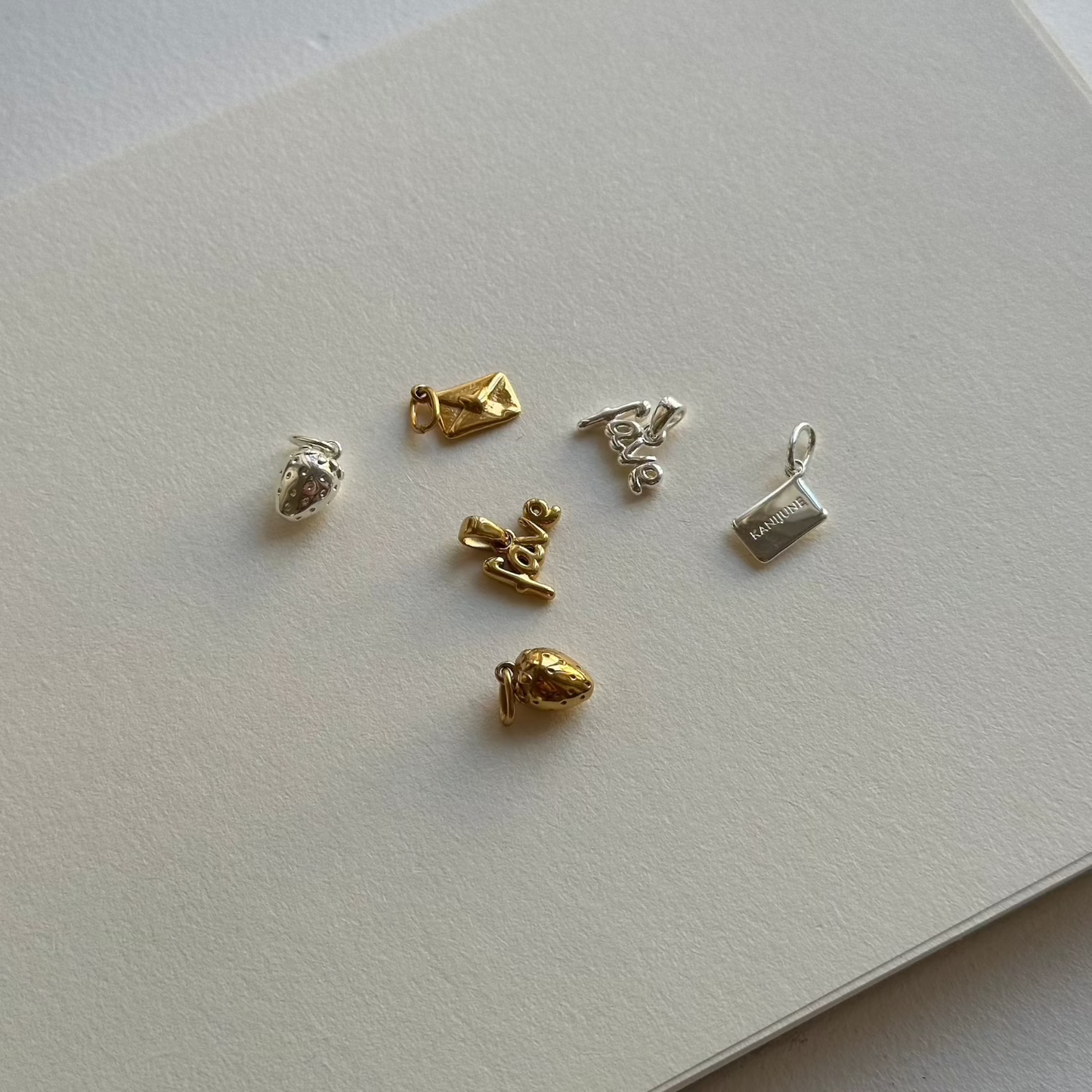 gold and silver charms on a white paper