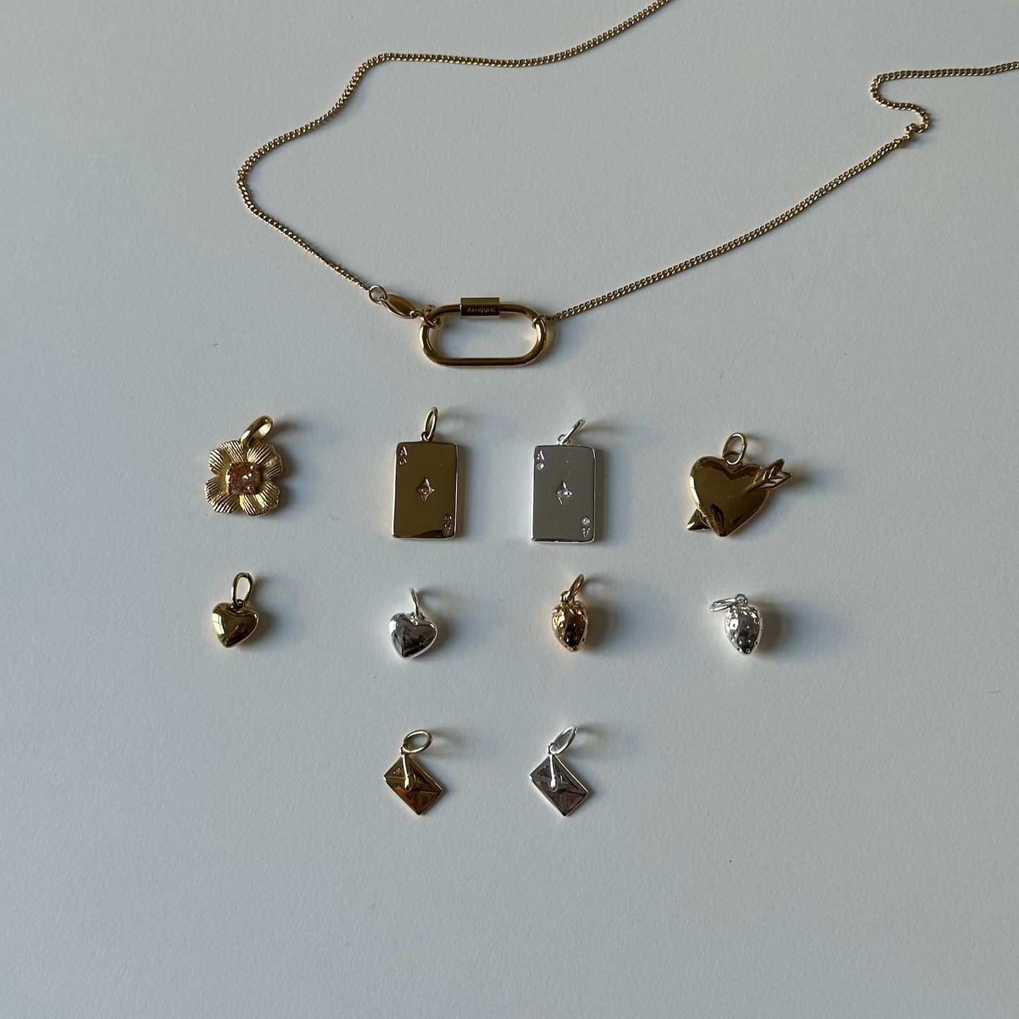 mix and match necklace with charms in rows on white background